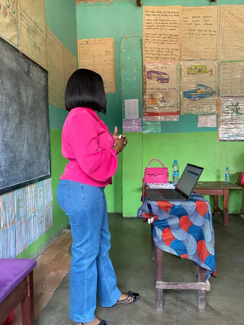 A presenter teaching in a classroom decorated with learners’ work