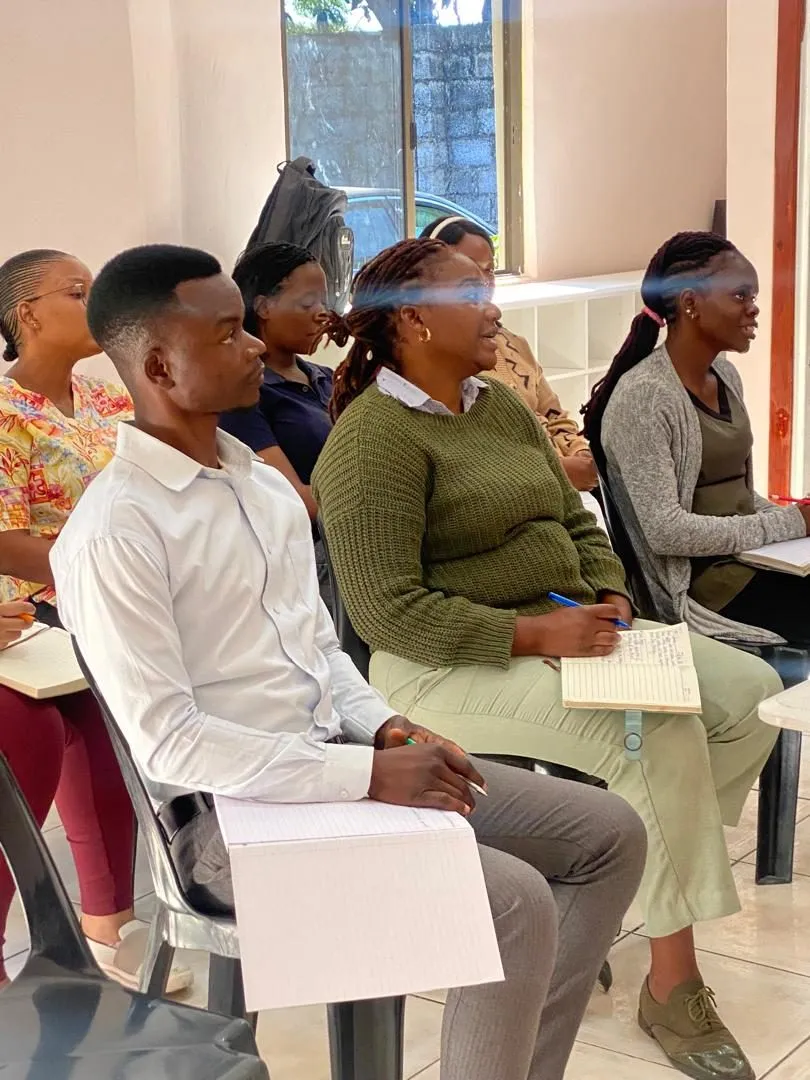 Participants taking notes during a training session