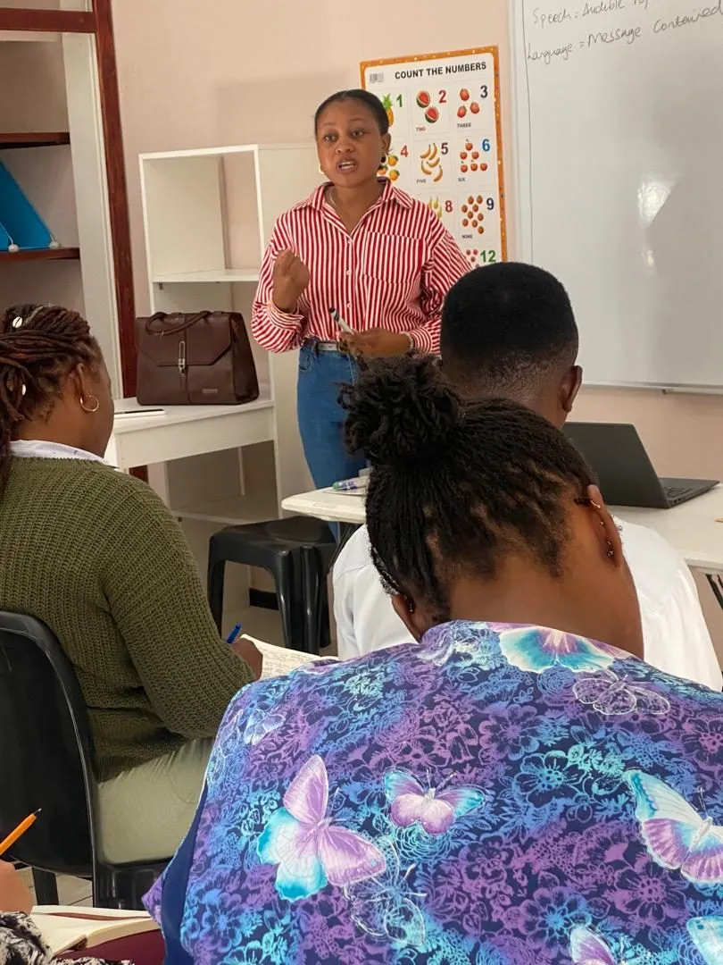 A facilitator explaining a point during a training session